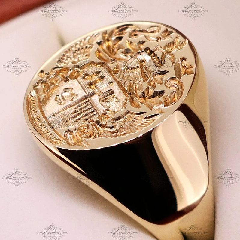 Seal engraved coat of arms on a yellow oxford oval signet ring presented in a ring box