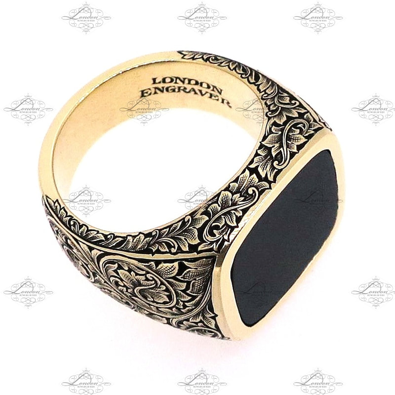 Yellow gold signet ring set with onyx, cushion shape, with hand engraved floral and scroll patternwork on shoulders and shank