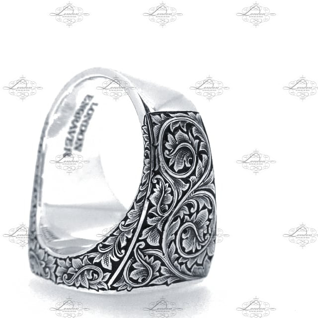 Large cushion signet ring with hand engraved leaf scrollwork on the shoulders, with black enamel