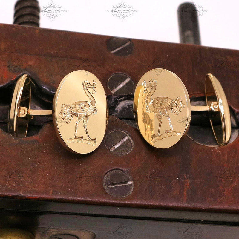 T-bar yellow gold cufflinks hand engraved with a surface engraved family crest - emu holding a key