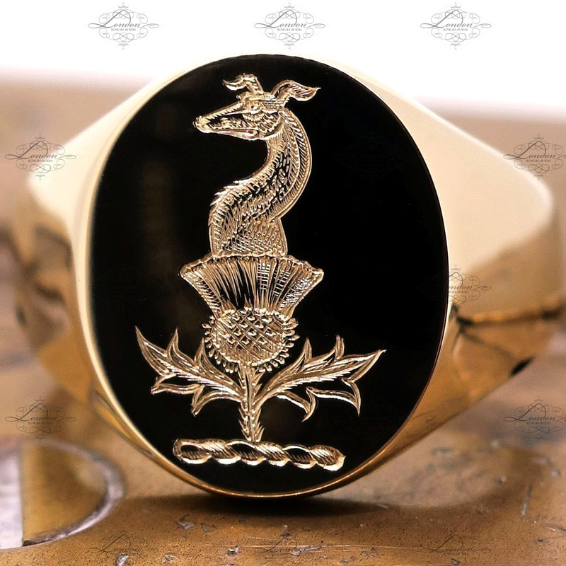 Greyhound and thistle family crest, surface engraved on a yellow gold signet ring