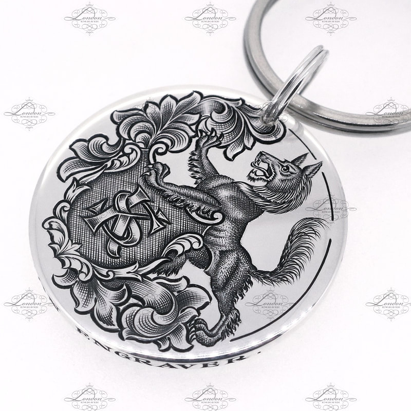 Sterling silver handmade keyring with a wolf crest holding a shield with custom KS initials