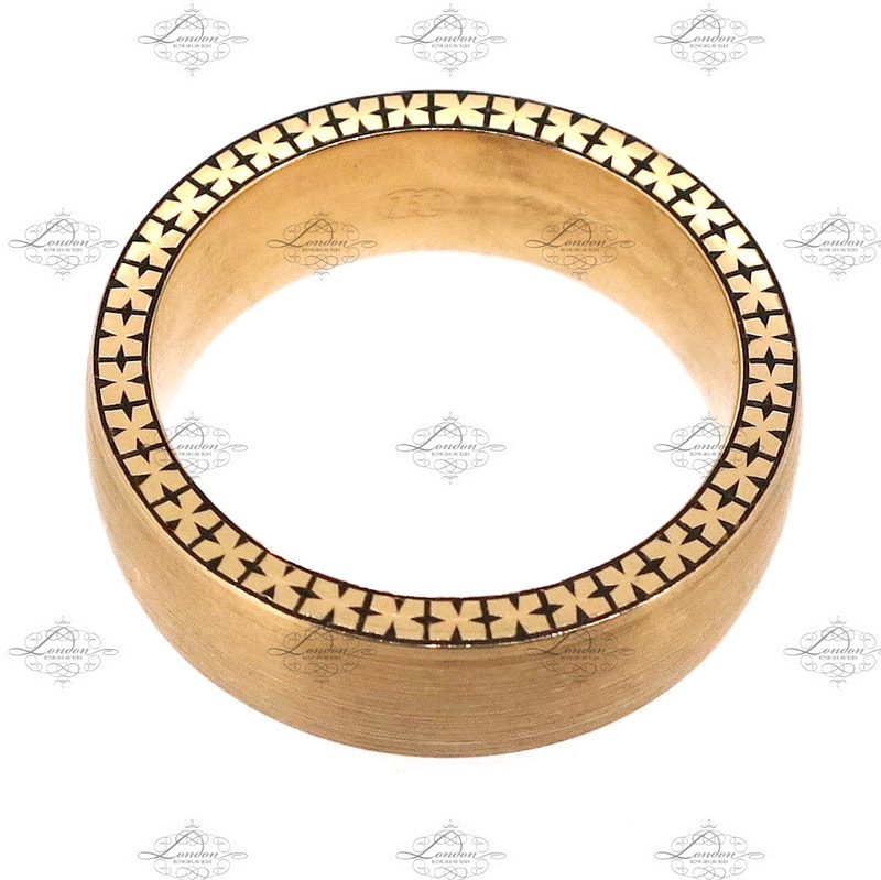 cross style patternwork hand engraved around the edge of a gents yellow gold wedding band