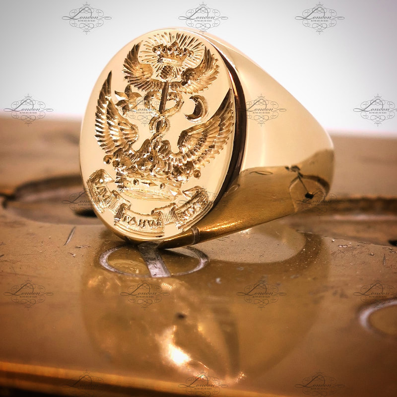 Seal engraved custom design on a yellow gold oxford oval signet ring