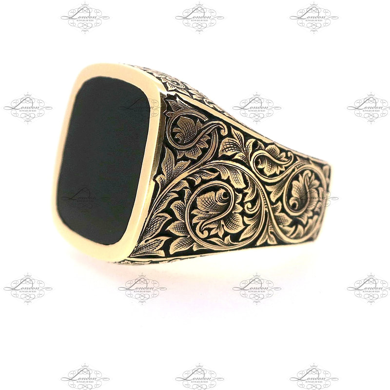 9ct yellow gold cushion signet ring set with onyx. Hand engraved leaf scroll patternwork on the shoulders