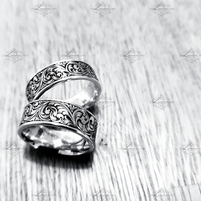 A pair of matching wedding rings with hand engraved scrollwork