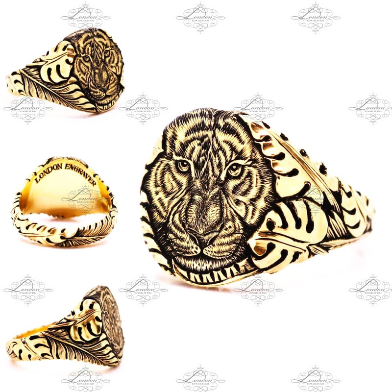 Yellow gold signet ring hand engraved with a tigers face emerging from carved jungle leaves